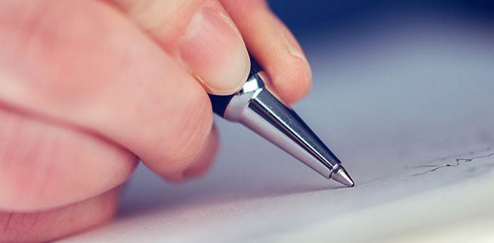 Core Values: Close-up of a pen tip being using to write on a peice of paper.