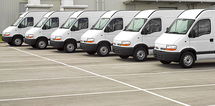 Motor Fleet Insurance: A row of six white vans.