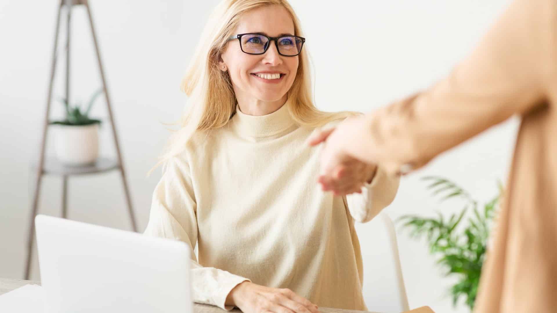 Business owner and insurance broker shaking hands after arranging private medical insurance for SME employees