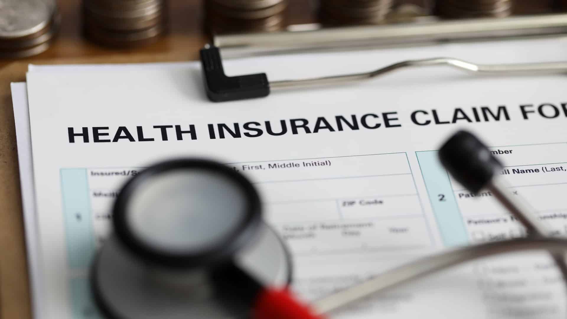 Health insurance claim form with stethoscope — private medical insurance provides UK employees with faster access to diagnosis and treatment