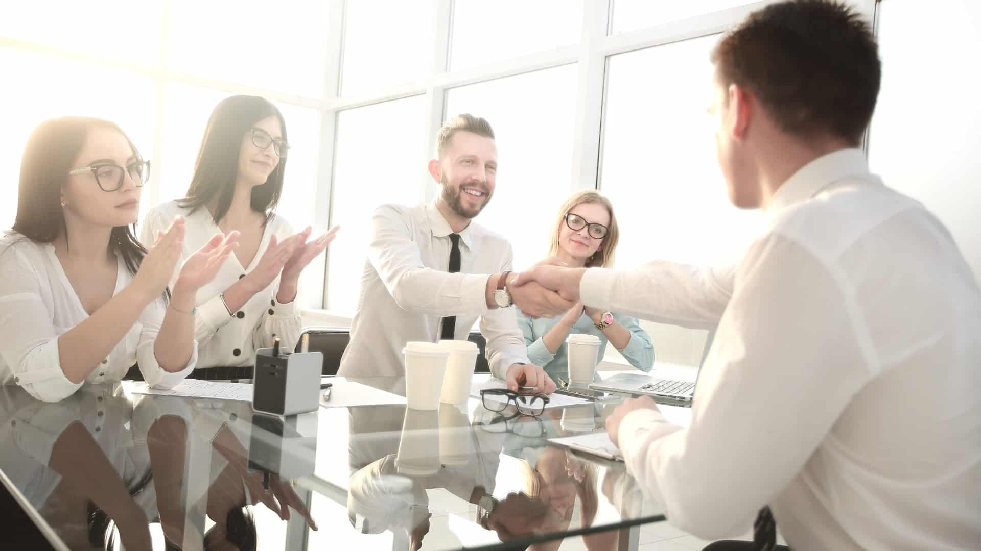 A professional business team in a meeting — private medical insurance helps UK SMEs manage sickness absence and retain their workforce