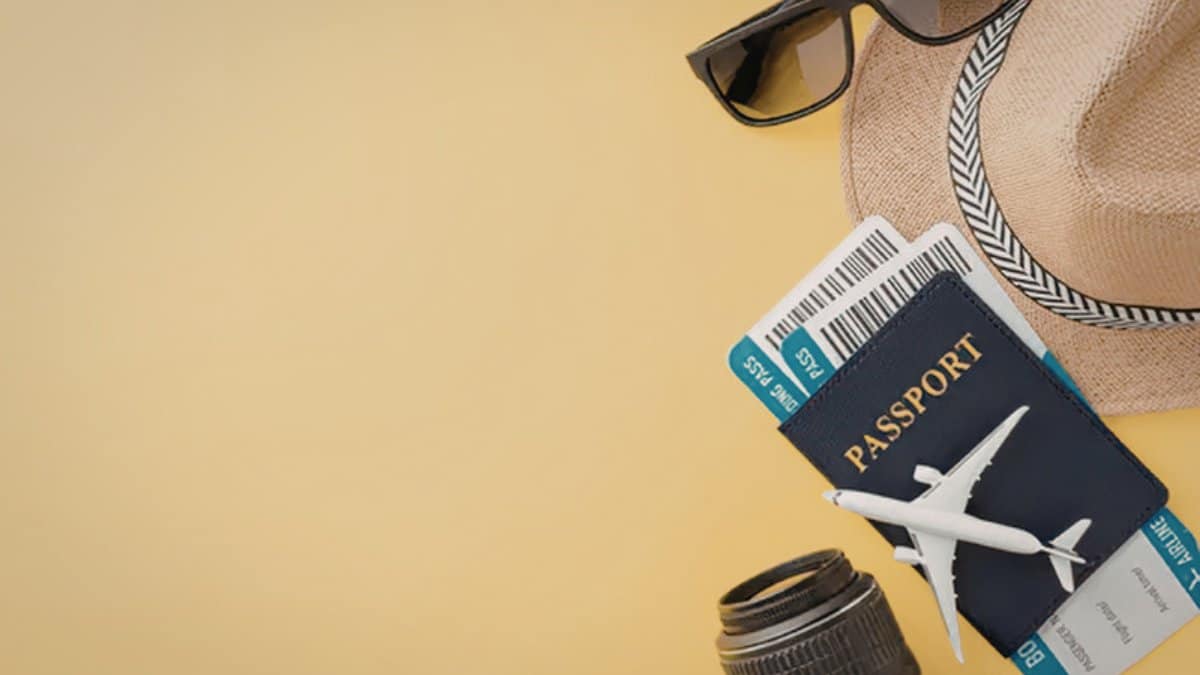 Travel planning flat-lay with passport, boarding pass and toy aeroplane