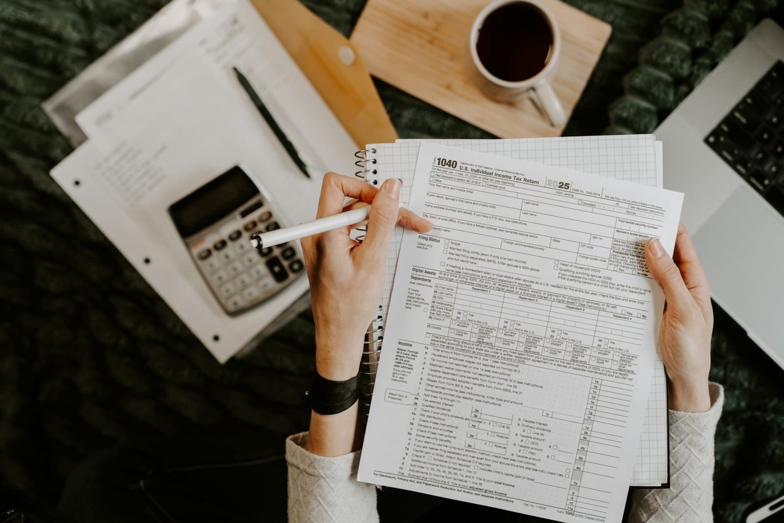 Hands working through financial figures with a calculator